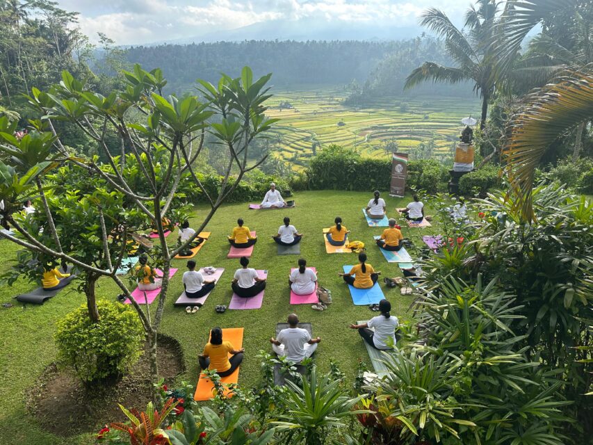 Outdoor yoga session overlooking green hills in Bali